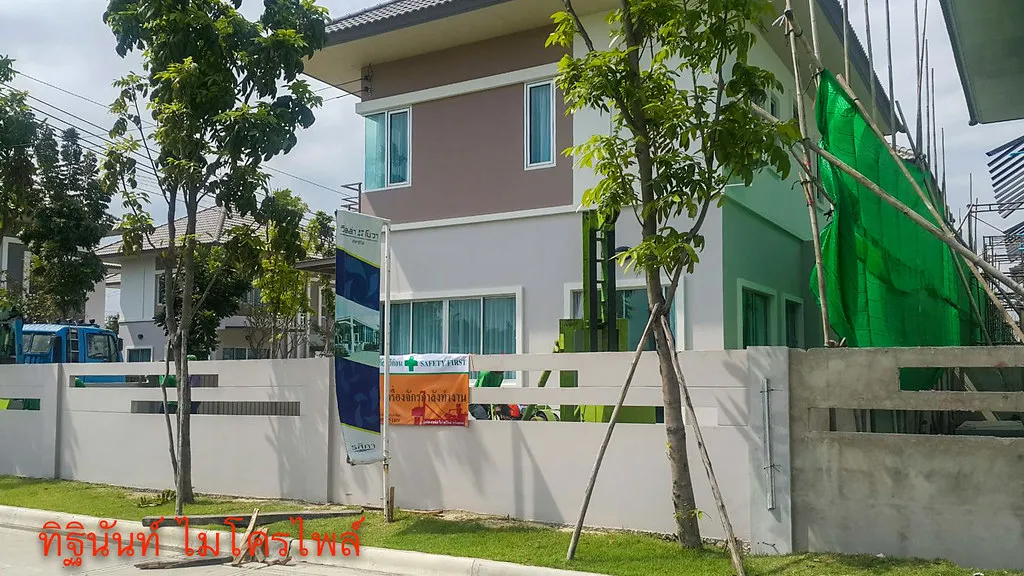 บ้านวิลล่า โนวา พร้อมตาข่ายสีเขียวคลุมแนวพื้นที่ทำงานด้านข้าง